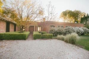 a brick house with a walkway in front of it at CHACRA con VISTA AL CAMPO DE POLO in Pilar