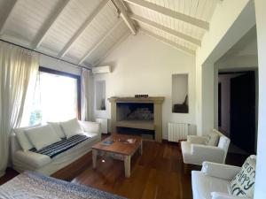 a living room with a couch and a table at CHACRA con VISTA AL CAMPO DE POLO in Pilar +54 photos