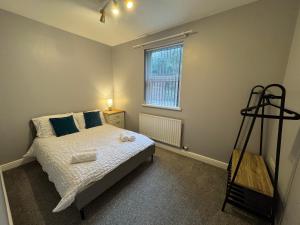 a bedroom with a bed and a window at Omega Apartment - 3 Bedrooms - Sleeps 5 in Whitehaven