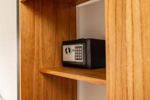 a microwave sitting on a shelf in a cabinet at Las Violetas in Luján