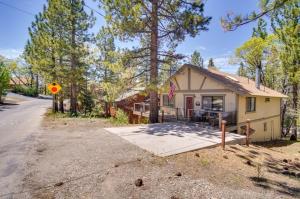 a house with a flag on the side of the road at The Drowsy Den With Firepit & BBQ Plus Large Patio in Big Bear Lake