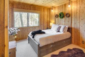 a bedroom with a bed in a wooden room at The Drowsy Den With Firepit & BBQ Plus Large Patio in Big Bear Lake