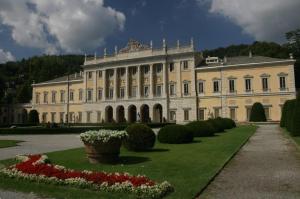 a large building with a garden in front of it at La Casa de Papel in Como