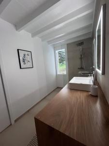 a bathroom with a white tub and a sink at Lakay zot in Le Vauclin