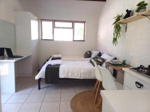 a small bedroom with a bed and a kitchen at Studio 12 in Strand +7 photos