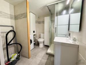 a small bathroom with a toilet and a sink at Le Repaire de Leucate - Confort près de la Plage in Leucate-Plage +14 photos