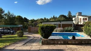 a cat sitting next to a swimming pool at Los Prados in Villa Giardino