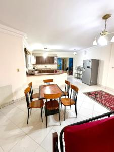 a kitchen and dining room with a table and chairs at First row villa on the sea in the village of Aquarius family only in Ain Sokhna