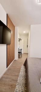 Un dormitorio con una cama y un televisor de pantalla plana. en ALMAR We Go Puerto Santiago! Habitaciones Privadas en piso compartido- Private Rooms in modern shared Apartment, en Puerto de Santiago