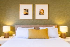 a bedroom with a white bed with two lamps at Turtle Beach Resort - Accor Vacation Club Apartments in Gold Coast +51 photos