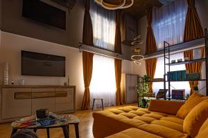 a living room with a couch and a tv at Apartament ACs Studio in Sighişoara