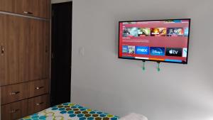 a bedroom with a flat screen tv hanging on the wall at Lonova By Relajao in Popayan