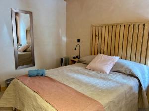 a bedroom with a bed with a blue bow on it at Casa Coco H2 Arena in San Cristóbal de Las Casas