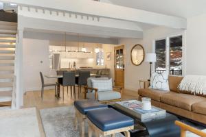 a living room with a couch and a table at Novelle Chalet - Renovated, Chic Contemporary Home on Gore Creek with Hot Tub in Vail +30 photos
