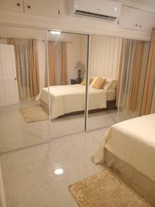 a bedroom with two beds and a mirror at Virginias Place in The Valley