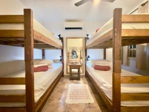 a room with three bunk beds and a staircase at Pousada Family Consulado Americano in São Paulo