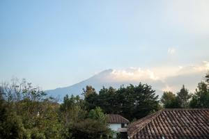 a mountain in the distance with houses and trees at Indian Palace Hotel Boutique Spa & Restaurante in Antigua Guatemala