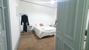 a small bedroom with a bed and a hallway at Hostal 2 in Buenos Aires