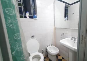 a small bathroom with a toilet and a sink at Hostal 2 in Buenos Aires
