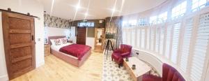 a bedroom with a bed and a chair and a window at Burton Stone Inn in York