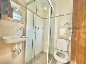 a bathroom with a toilet and a sink and a shower at Pousada Family Consulado Americano in São Paulo