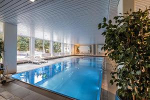 a large swimming pool in a large house at Apartment with Pool, Sauna & Gym in Laax
