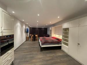 a bedroom with a bed and a kitchen with a table at Apartment with Pool, Sauna & Gym in Laax +18 photos
