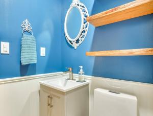 a bathroom with a sink and a mirror and a toilet at Victorian Lake Oasis Hot Tub Private Lakefront in Lake Huntington +25 photos