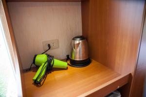 a coffee maker and an umbrella on a wooden shelf at Taipei Hua Zhung Campsite in Taipei