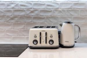 a toaster and coffee maker sitting on a kitchen counter at Turtle Beach Resort - Accor Vacation Club Apartments in Gold Coast
