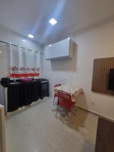a room with a table and a kitchen with a table and chairs at Flat Praia Dourada 5 in Maragogi +4 photos