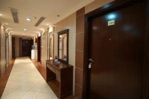 a hallway with a door with the exit sign on it at Durrat Mina Hotel in Makkah