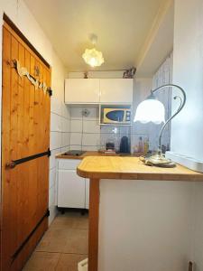a kitchen with a wooden counter top and a door at Charenton1 Studio Gare de Lyon in Paris