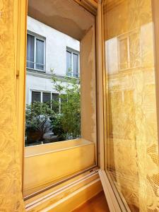 an open window with a view of a building at Charenton1 Studio Gare de Lyon in Paris +4 photos