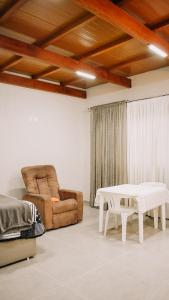 a living room with a couch and a table at Tiny House - Centro Concórdia in Concordia +8 photos