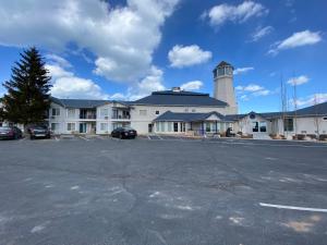 a large building with a lighthouse in a parking lot at Inn Building Condo 103 updated, pool side view in Garden City