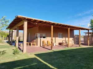 een paviljoen met een tafel en stoelen in een tuin bij Cabañas EL AGUARIBAY in Barreal