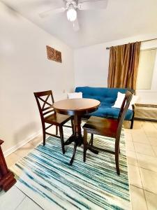 a living room with a table and a blue couch at Marina Vista Condo III in New Bern