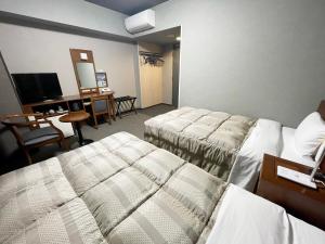 Postel nebo postele na pokoji v ubytování Hotel Route-Inn Dai-ni Ashikaga