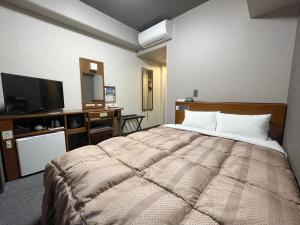 Postel nebo postele na pokoji v ubytování Hotel Route-Inn Dai-ni Ashikaga