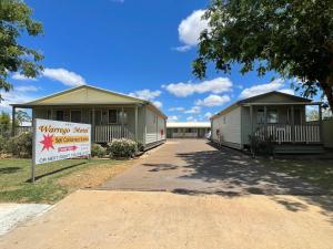 two mobile homes with a sign in front of them at Warrego Motel in Charleville