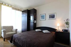 a bedroom with a bed and a chair and a window at Apartment Ultra Split in Split