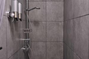 a shower with a shower head in a bathroom at Javelot1 Cosy studio paris13 10min to Louvre in Paris