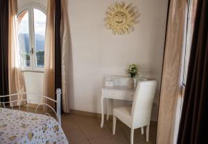a bedroom with a desk and a chair and a bed at B&B Raggio di Sole in Fluminimaggiore +21 photos