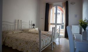 a bedroom with two beds and an open door at B&B Raggio di Sole in Fluminimaggiore