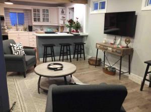 a kitchen and living room with a table and chairs at Quiet Lake View Firepit, Deck, BBQ, 3 Winery Walk in Essex