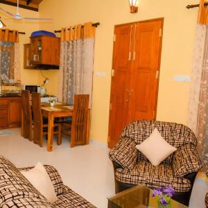 a living room with two chairs and a table at Serene Vista Villa, formerly Bungalows in Hikkaduwa