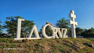 a large sign with a cow laying in front of it at Chacra Don Joaquin 1 in La Cruz