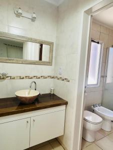 a bathroom with a sink and a toilet and a mirror at Pueblo Dorado in Malargüe +22 photos