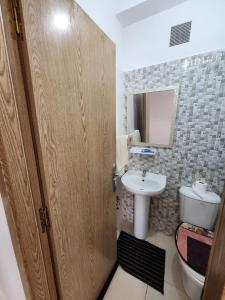 a bathroom with a toilet and a sink at Comfortable apartment near the Airport in Marrakech
